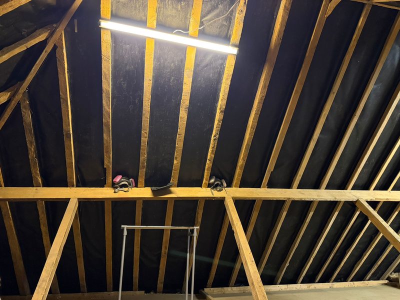 A boarded loft with a raised deck over the insulation and a strip light fitted
