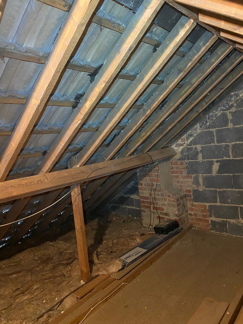 Fresh mineral wool insulation laid between and across loft joists