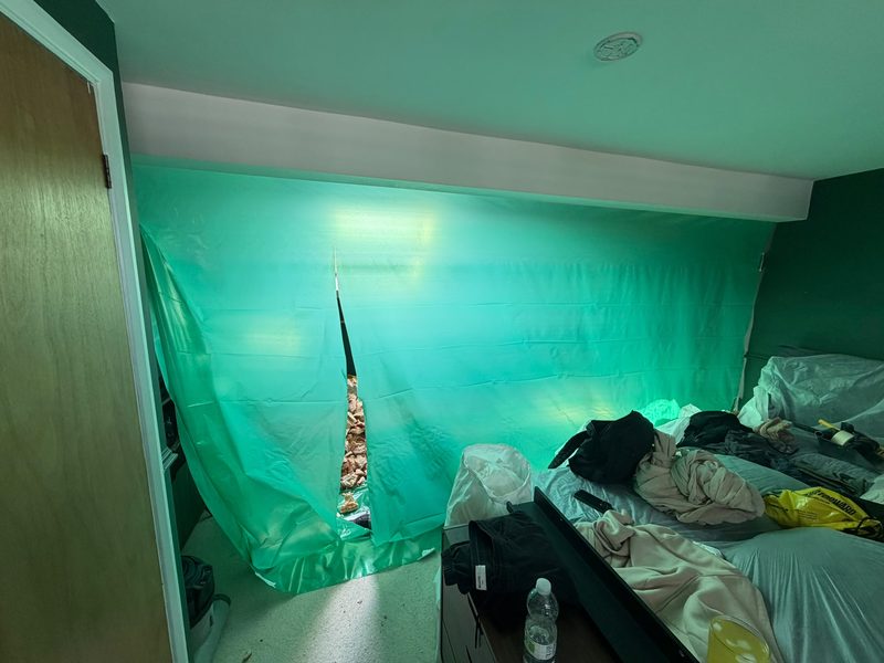 A bedroom sheeted in protective plastic before any work starts